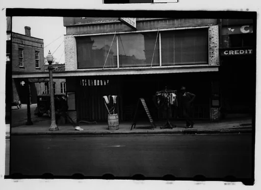 [Man with Clothesrack on Sidewalk, Natchez, Mississippi]