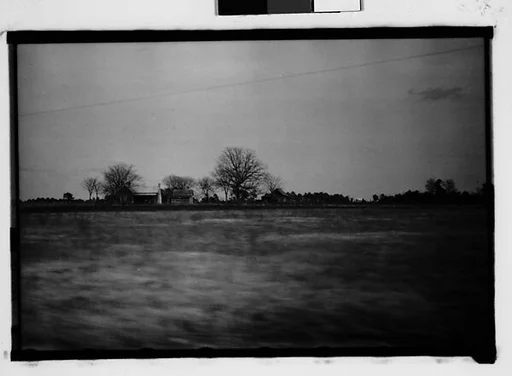 [Wooden Houses in Field, From Moving Automobile, Macon, Georgia]