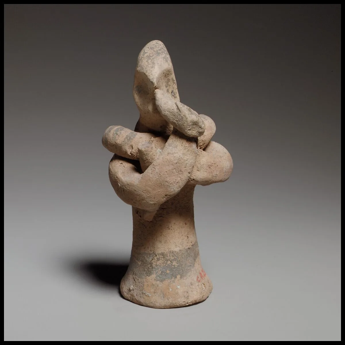 Standing male flute player with a serpent around his shoulders — Unknown