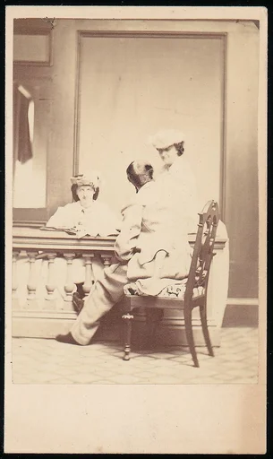 [Man, Seen from the Back, Conversing with Two Woman]