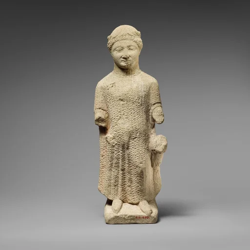 Limestone statuette of a boy holding a bird