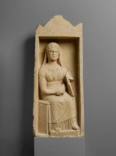 Limestone funerary monument with a seated woman