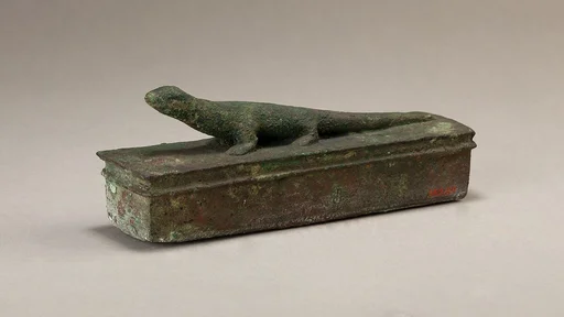 Shrine-shaped case for an animal mummy surmounted by a lizard