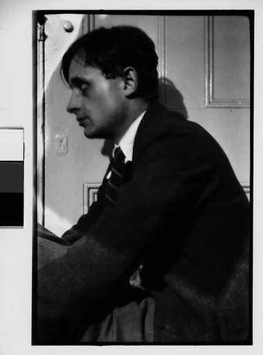 [Hanns Skolle Seated in Doorway (Left Profile)]