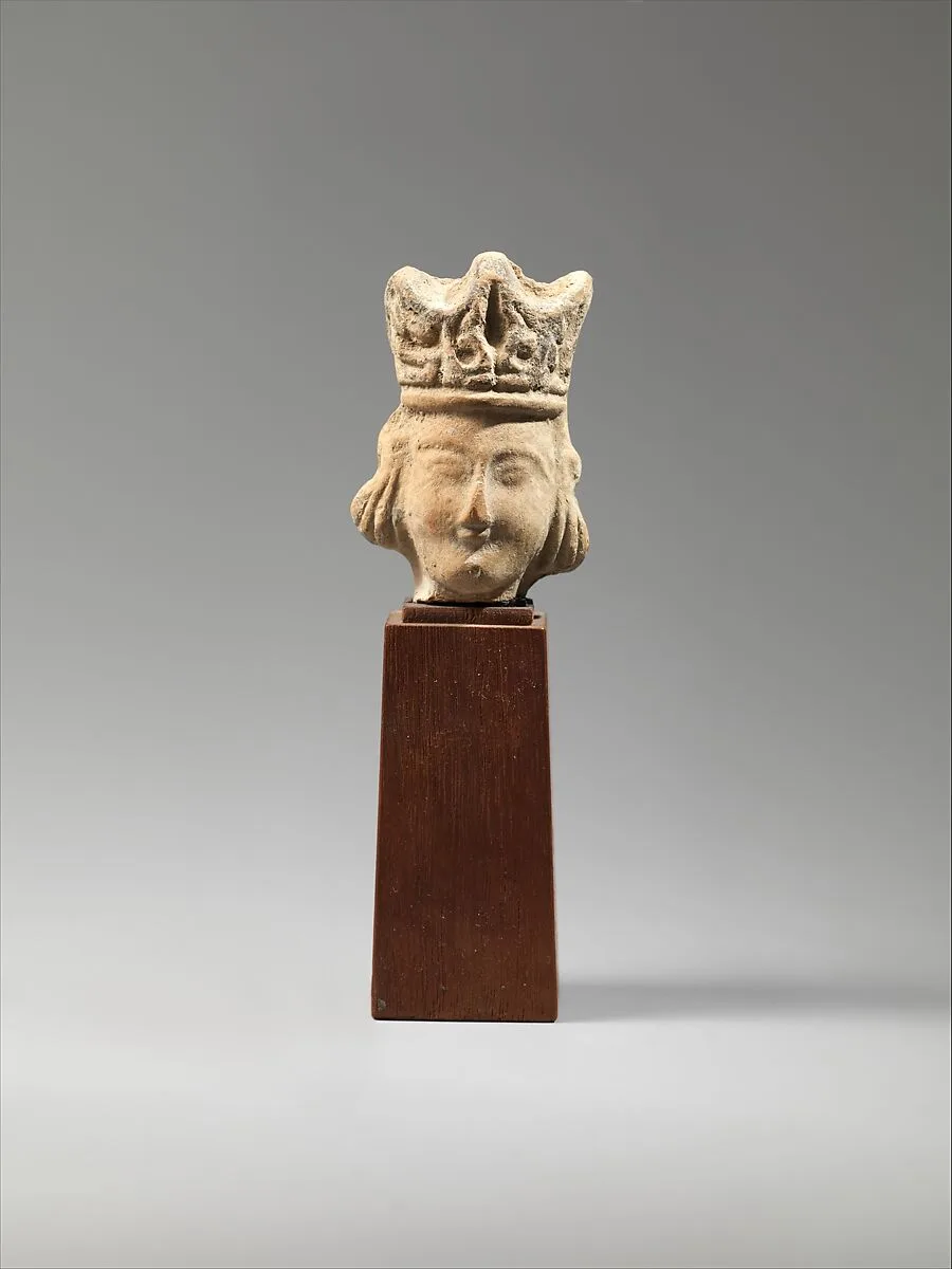 Head of a Figurine with an Elaborate Headdress — Unknown