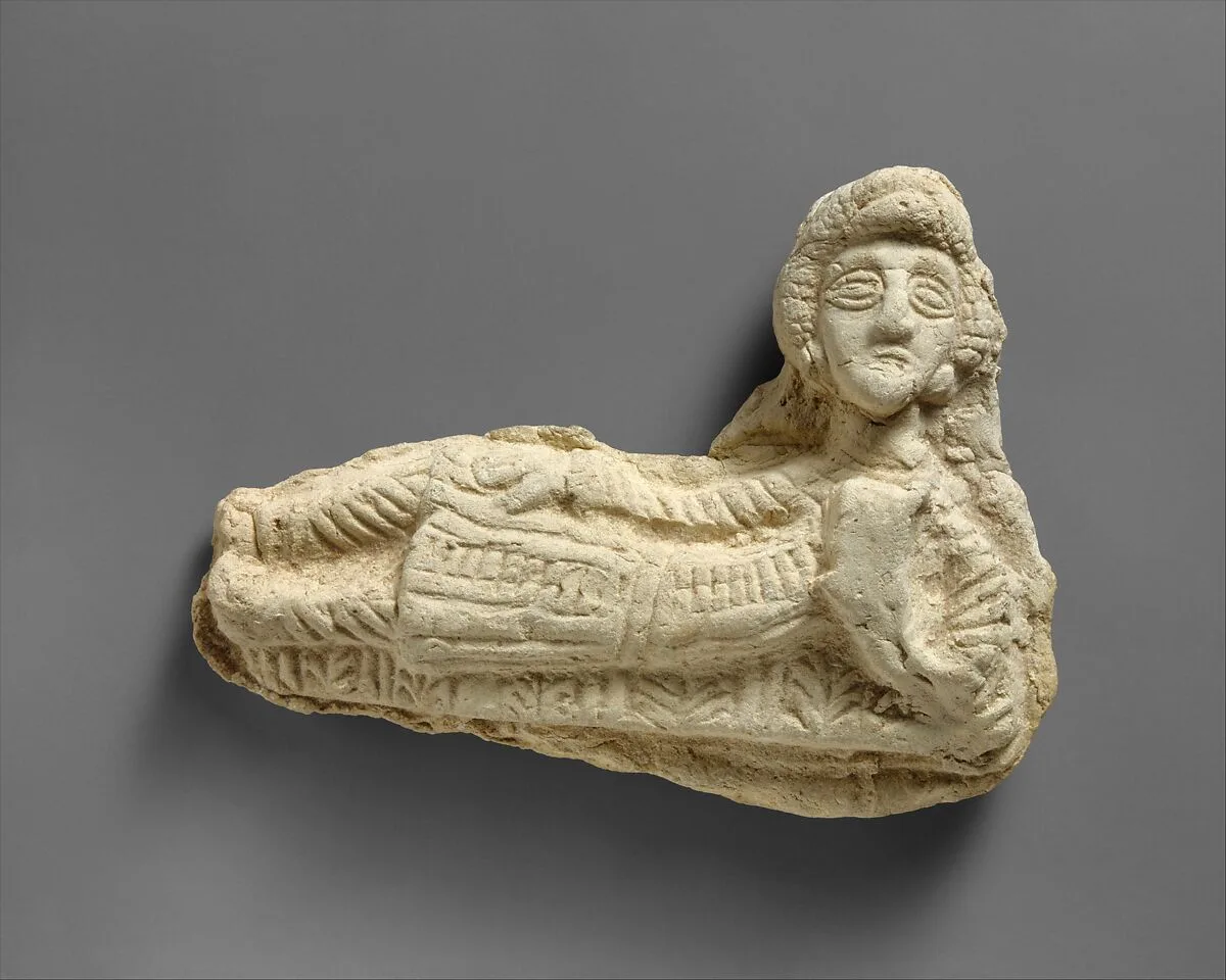 Plaque in the form of a reclining man — Unknown