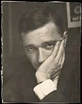 [Walker Evans, Chin in Hand, in Front of Resettlement Administration Poster]