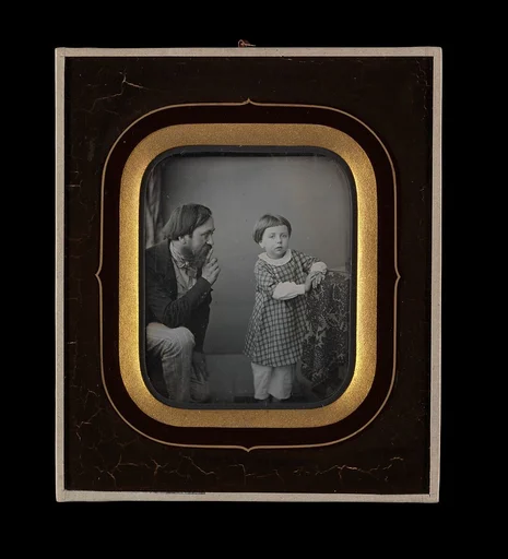 [Man Calming a Young Boy Posing before the Camera]