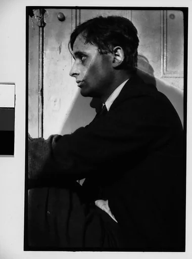 [Hanns Skolle Seated in Doorway (Left Profile)]