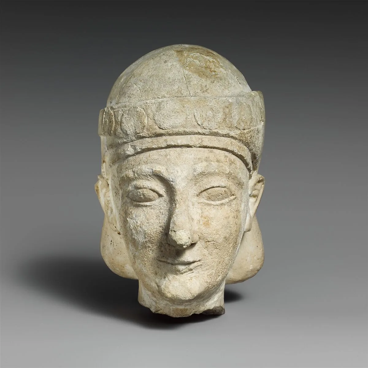 Limestone head of a beardless male with a diadem — Unknown