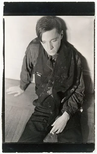 [Self-Portrait Seated on Floor, Holding Cigarette]