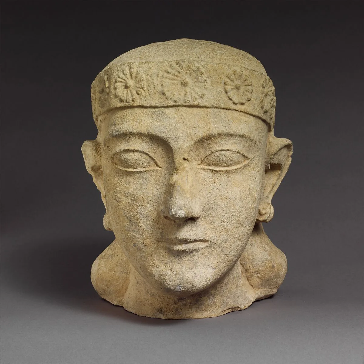 Limestone head of a beardless male with a diadem — Unknown