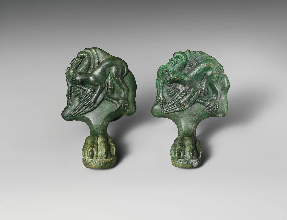 Pair of bronze cista (toiletries box) feet with panthers attacking cranes — Unknown