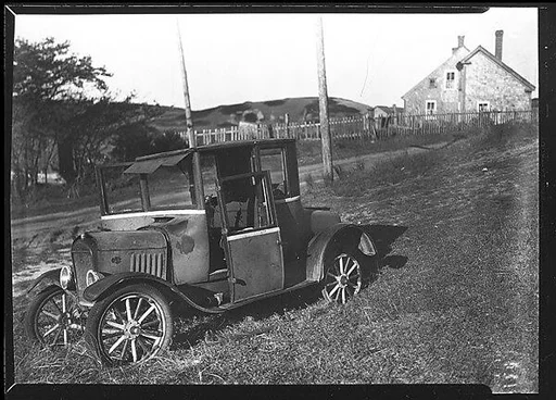 [Junked Roadster with Shingled House in Distance, Cape Cod, Massachusetts]