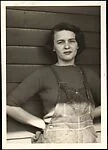 [Anna North Standing Before Clapboard Wall]