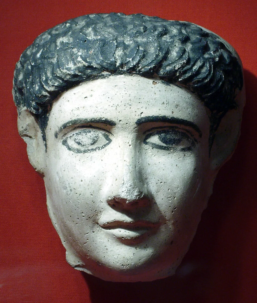 Small mask, possibly of a boy, with short locks combed to the front — Unknown
