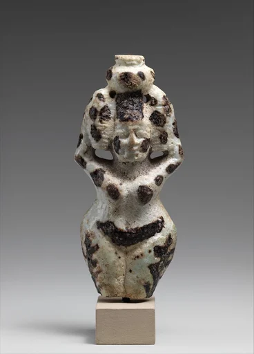Nude female figure holding a vase on her head