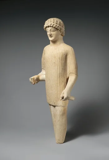 Limestone statue of a male votary wearing a wreath and long tunic
