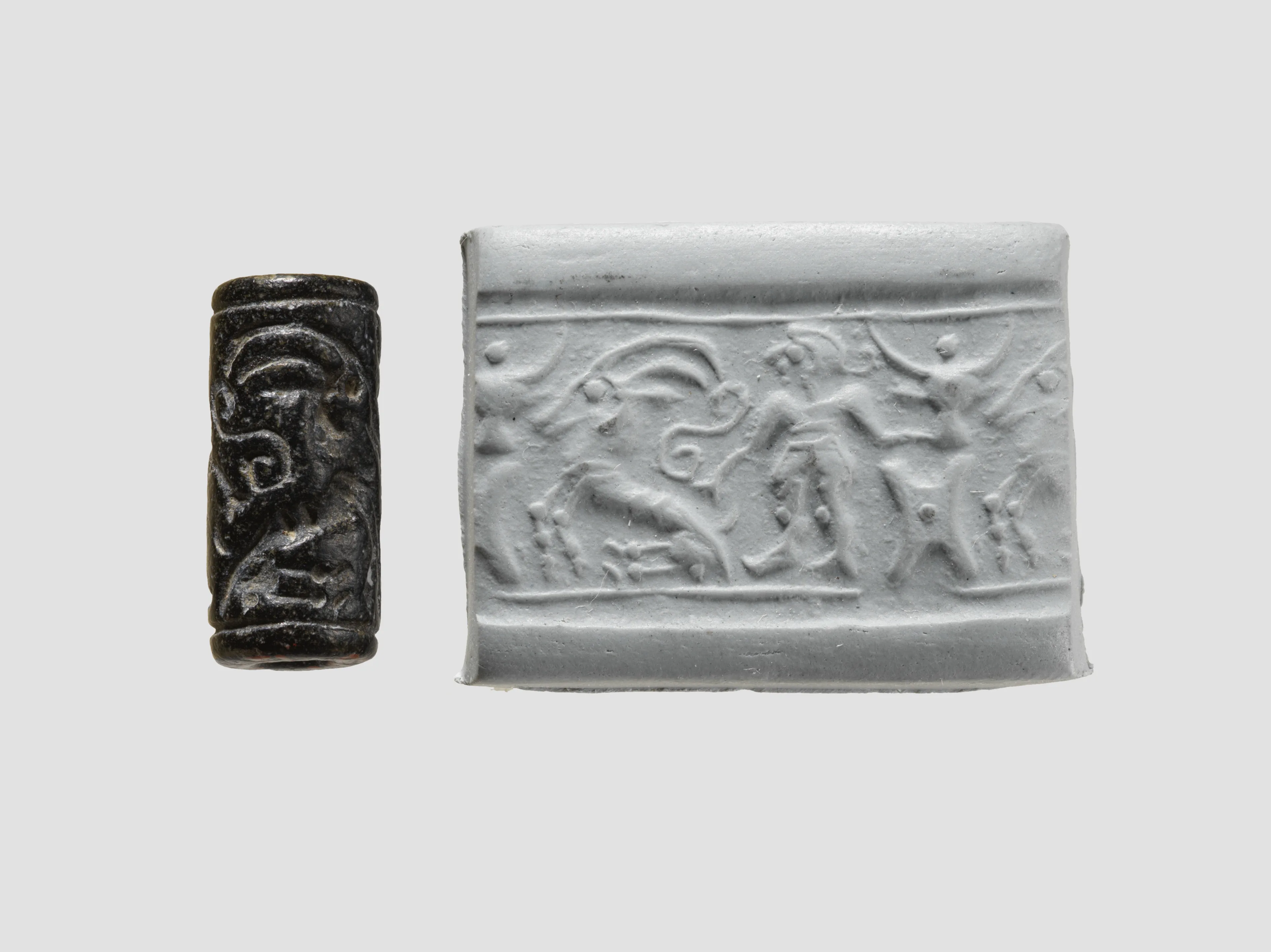 Cylinder seal and modern impression: man grasping an antelope, bull's head over ingot — Unknown