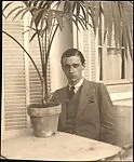 [Walker Evans Seated at Café Table with Potted Palm, Juan-les-Pins, France]