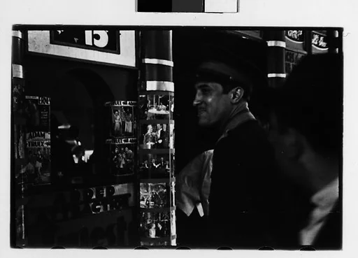 [Two 35mm Film Frames: Attendant Outside Movie Theater Ticket Window, New York City]