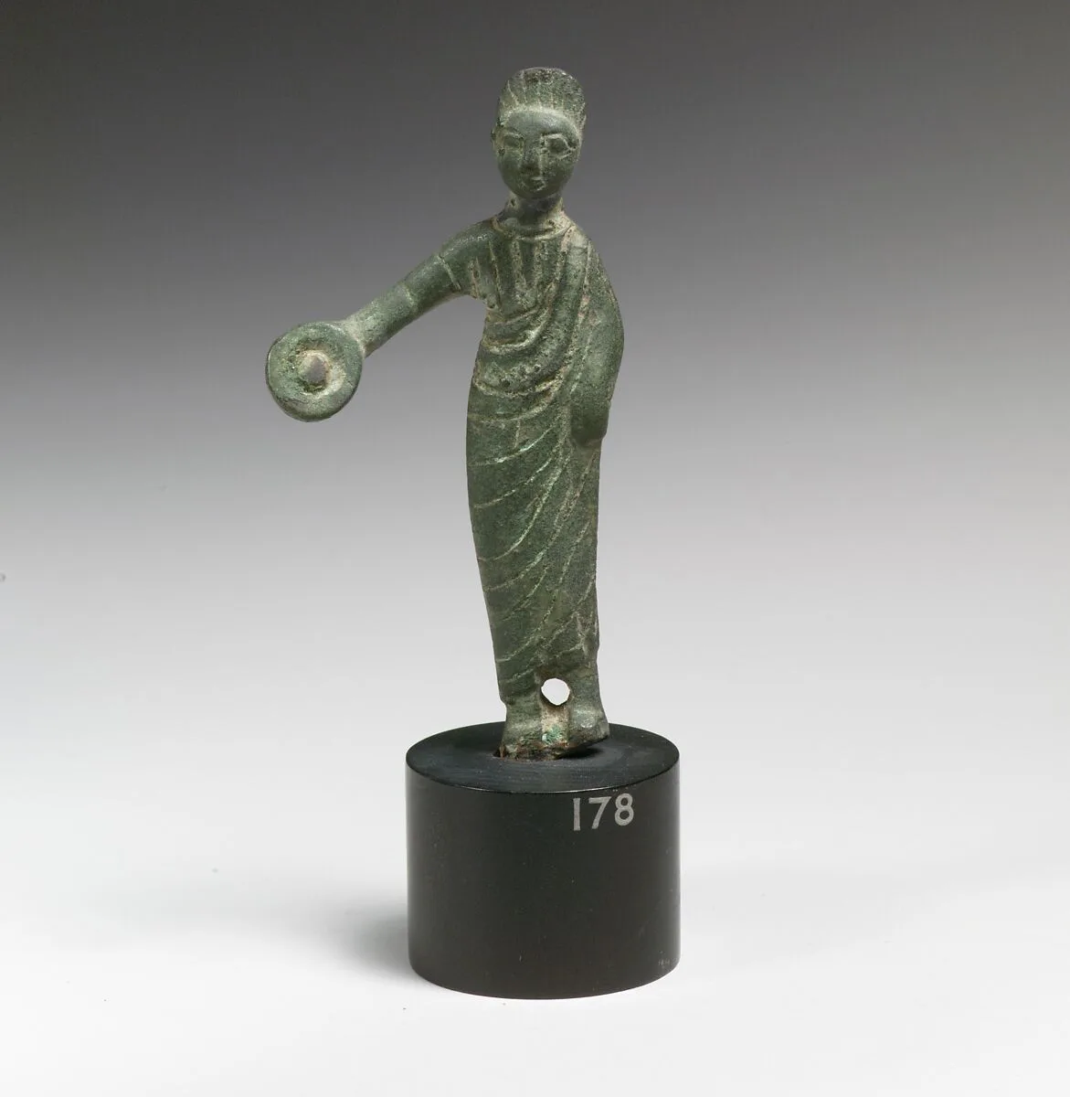 Statuette of a woman holding a phiale (libation vessel) — Unknown