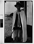 [Walker Evans in Hat and Cape Holding Cane]