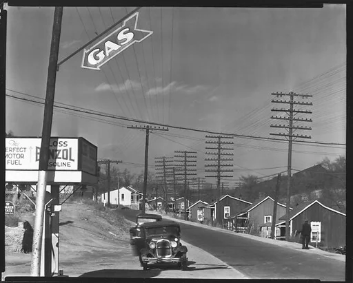 [Roadside Gas Station with Miners' Houses Across Street, Lewisburg, Alabama]