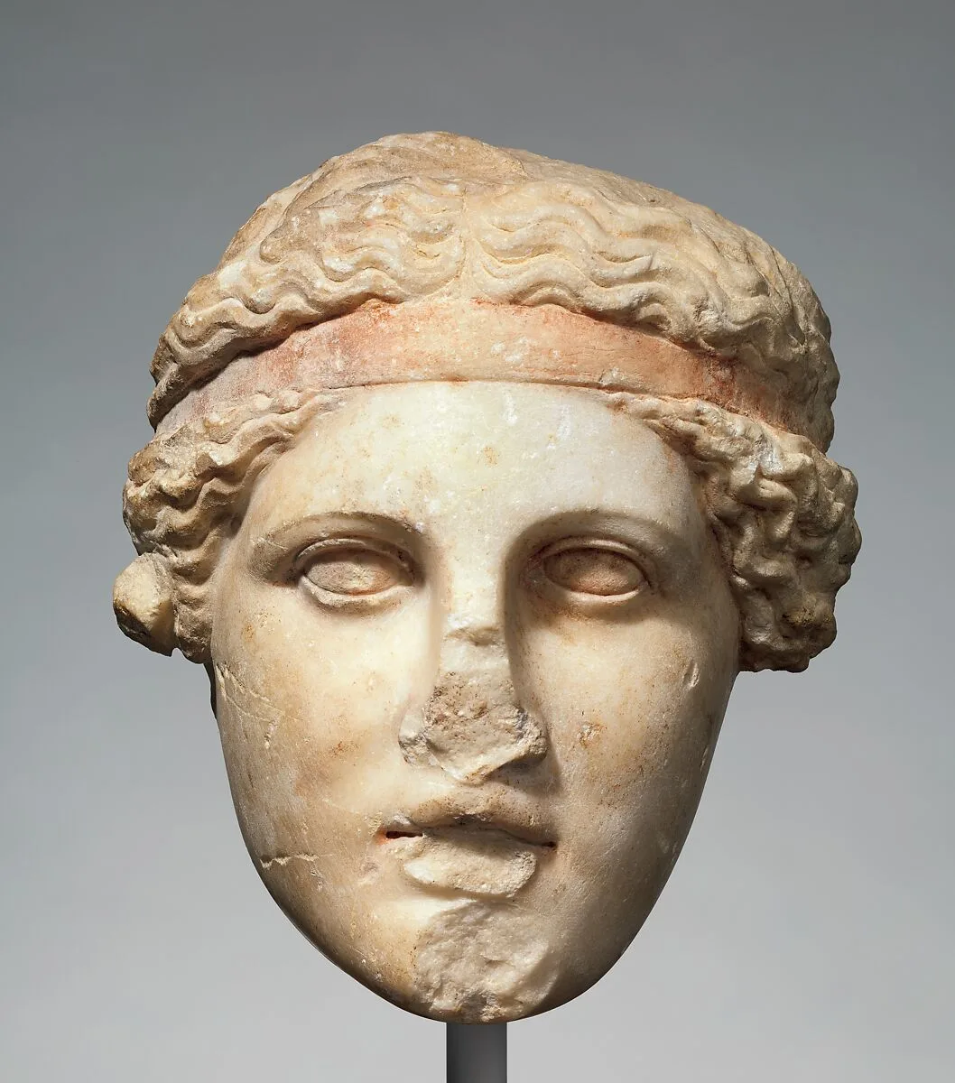 Marble head of a deity wearing a Dionysiac fillet — Unknown