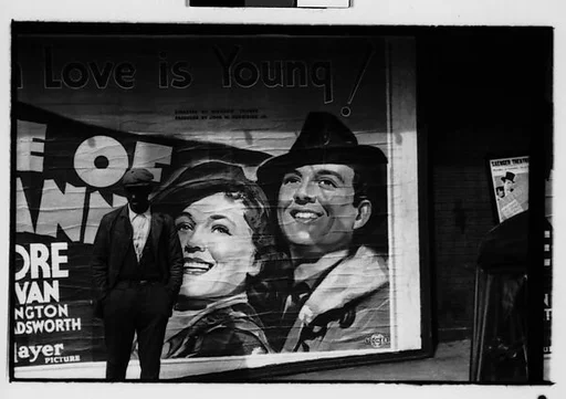 [Five 35mm Film Frames: Man on Sidewalk, in Front of Movie Poster, Vicksburg or New Orleans]