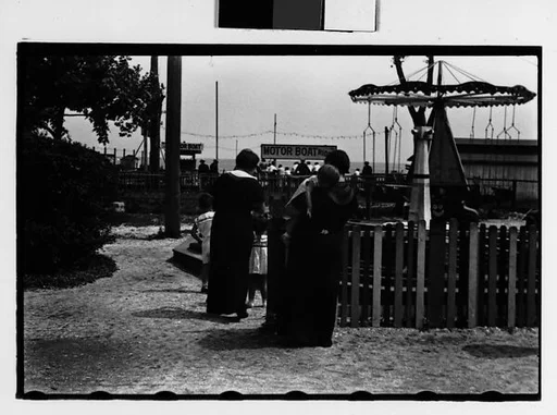 [Two 35mm Film Frames: Women and Children at Amusement Park Ride, From Behind]