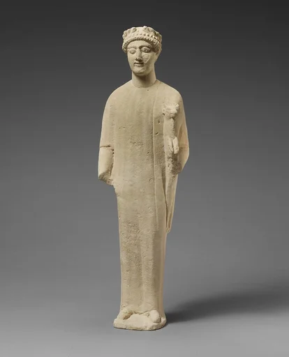 Limestone statuette of a beardless male votary with a wreath of leaves