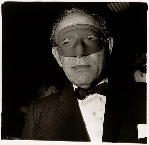 Masked man at a ball, N.Y.C. — Diane Arbus