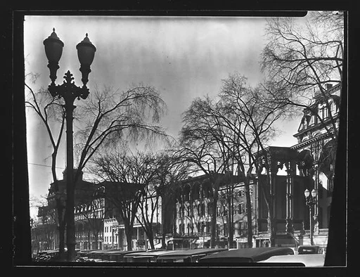 [Hotels and Parked Cars on Broadway with Street Lamp in Foreground, Saratoga Springs, New York]
