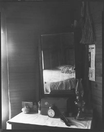 [Dressing Stand with Mirror Reflection of Bed]