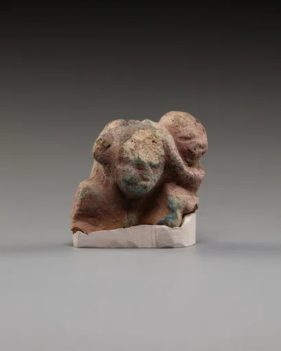 Upper part of a female figure with a child