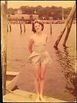 [Penelope Andrews in Bathing Suit Standing on Dock]