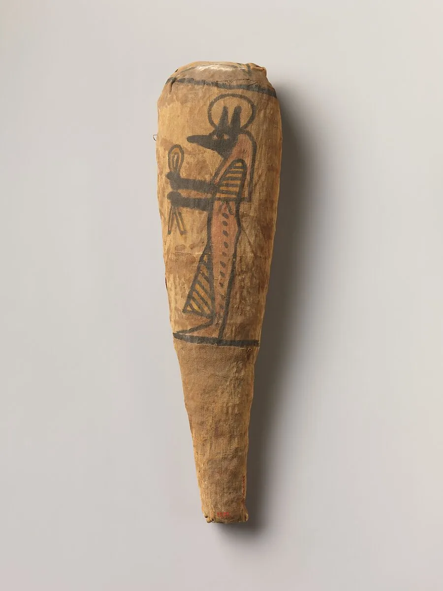 Sacred animal mummy in the form typical of a wrapped ibis, decorated with a figure of Duamutef — Unknown