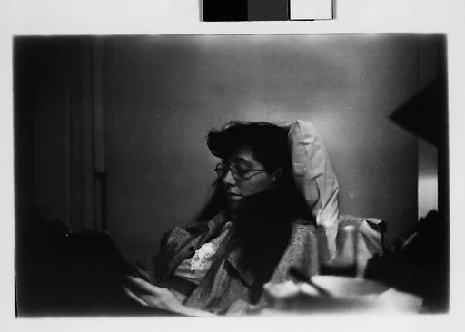 [Five 35mm Film Frames: Jane Smith Evans Reading Newspaper in Bed, New York City]