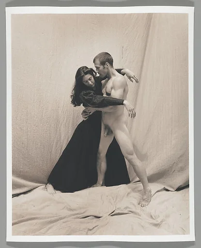 [Woman and Male Nude Posing before Cloth Backdrop]