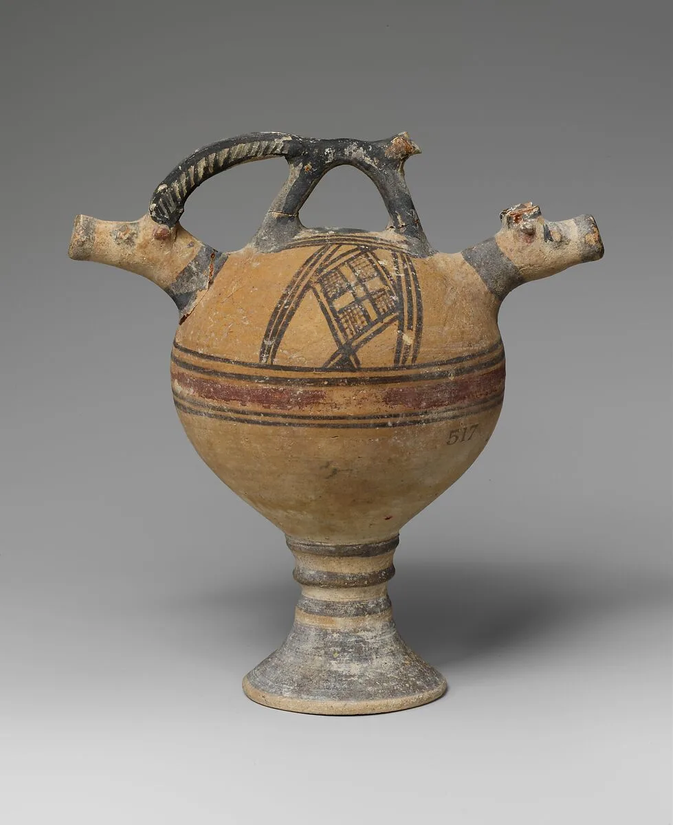 Terracotta vase on a high foot with two goats' heads in relief — Unknown