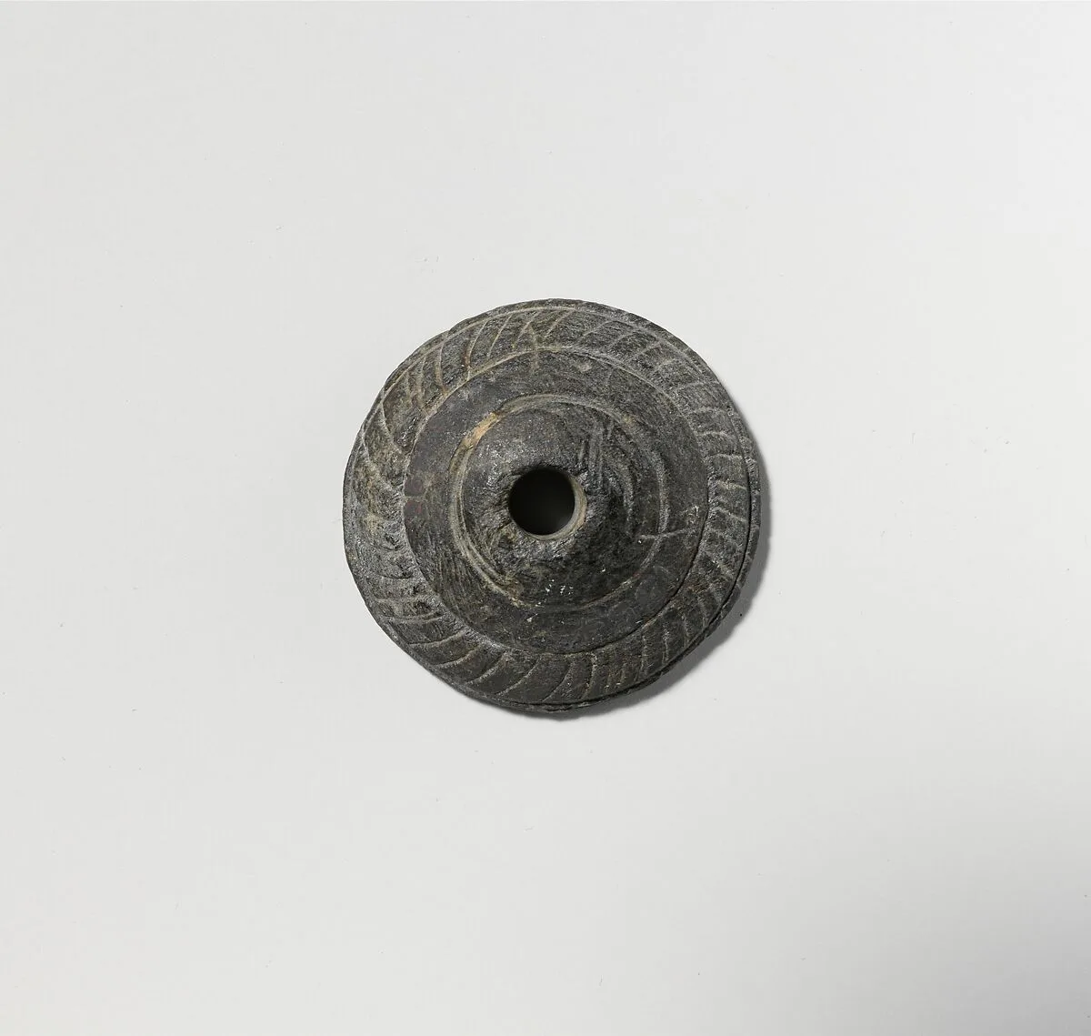 Schist spindle whorl — Unknown