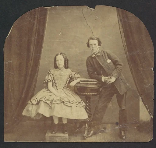 [Young Girl, Seated, with Young Boy, Leaning on Table]