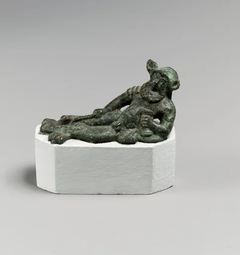 Bronze statuette of a satyr reclining on a lion's skin