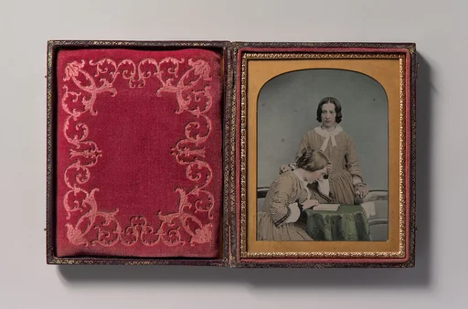 [Two Women Wearing Striped Dresses, One Standing, the Other Seated]