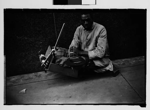 [Legless Man in Dolly on Street, New Orleans, Louisiana]