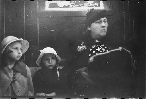[Five 35mm Film Frames: Subway Passengers, New York City: Two Little Girls in Bonnets Seated Next to Woman in Polkadot Dress]