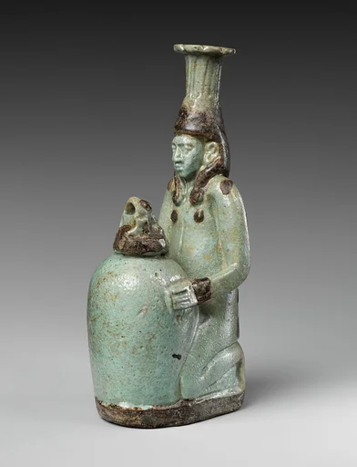 Faience double-spouted vessel in the form of a kneeling woman holding a jar