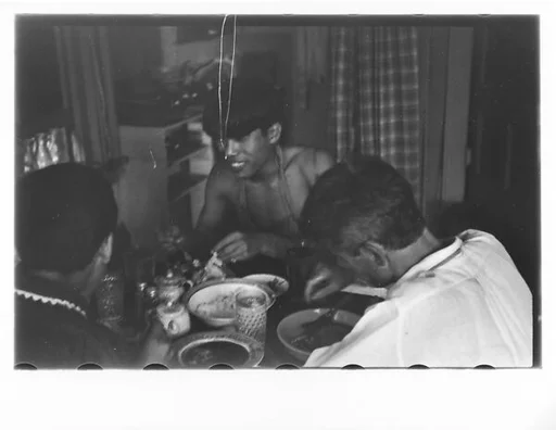 [Two 35mm Film Frames: Three Men Eating at Kitchen Table, Possibly New York City]