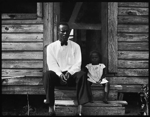 [Man Wearing Bow Tie and Young Girl Seated on Steps of House, Florida]